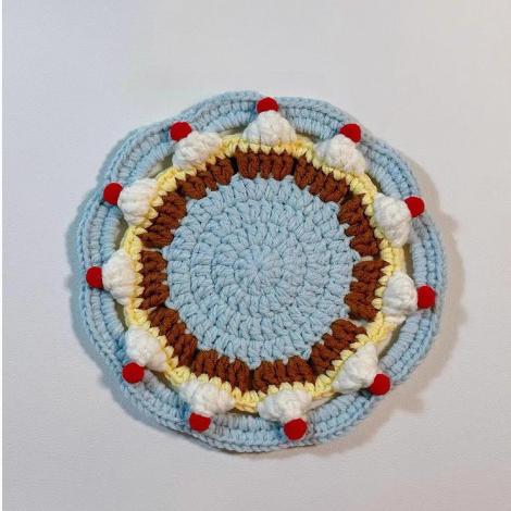 A Cream Cake Coaster Crochet Kit with soft yarn.