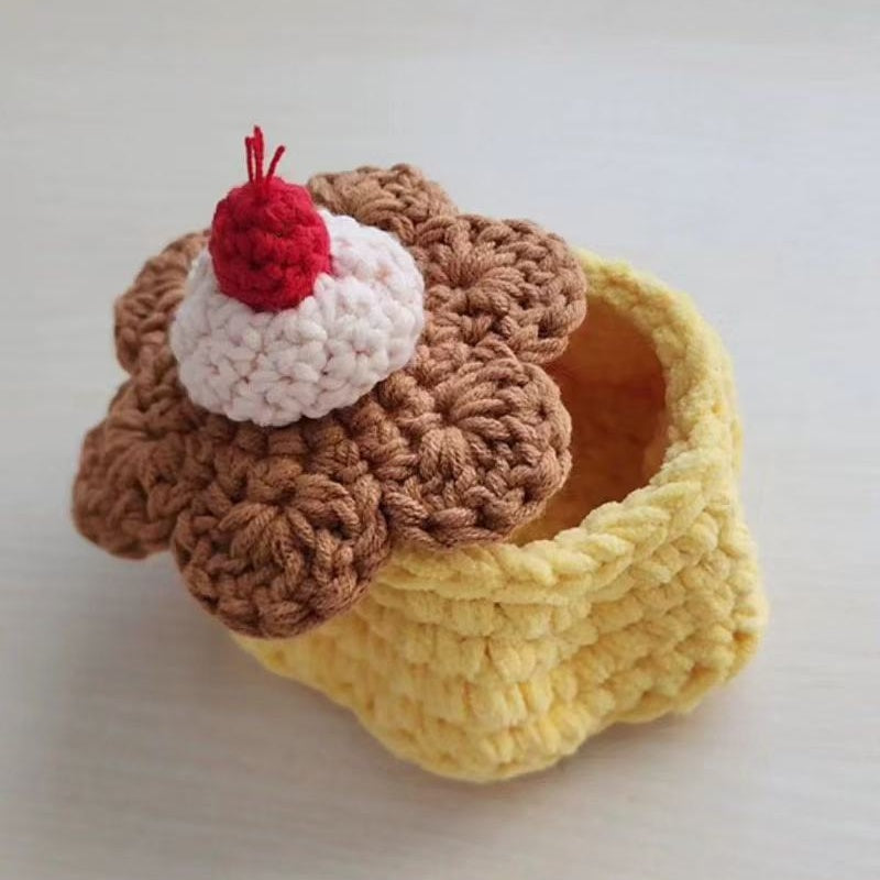 A person happily working on the Pudding Storage Box using the crochet kit.